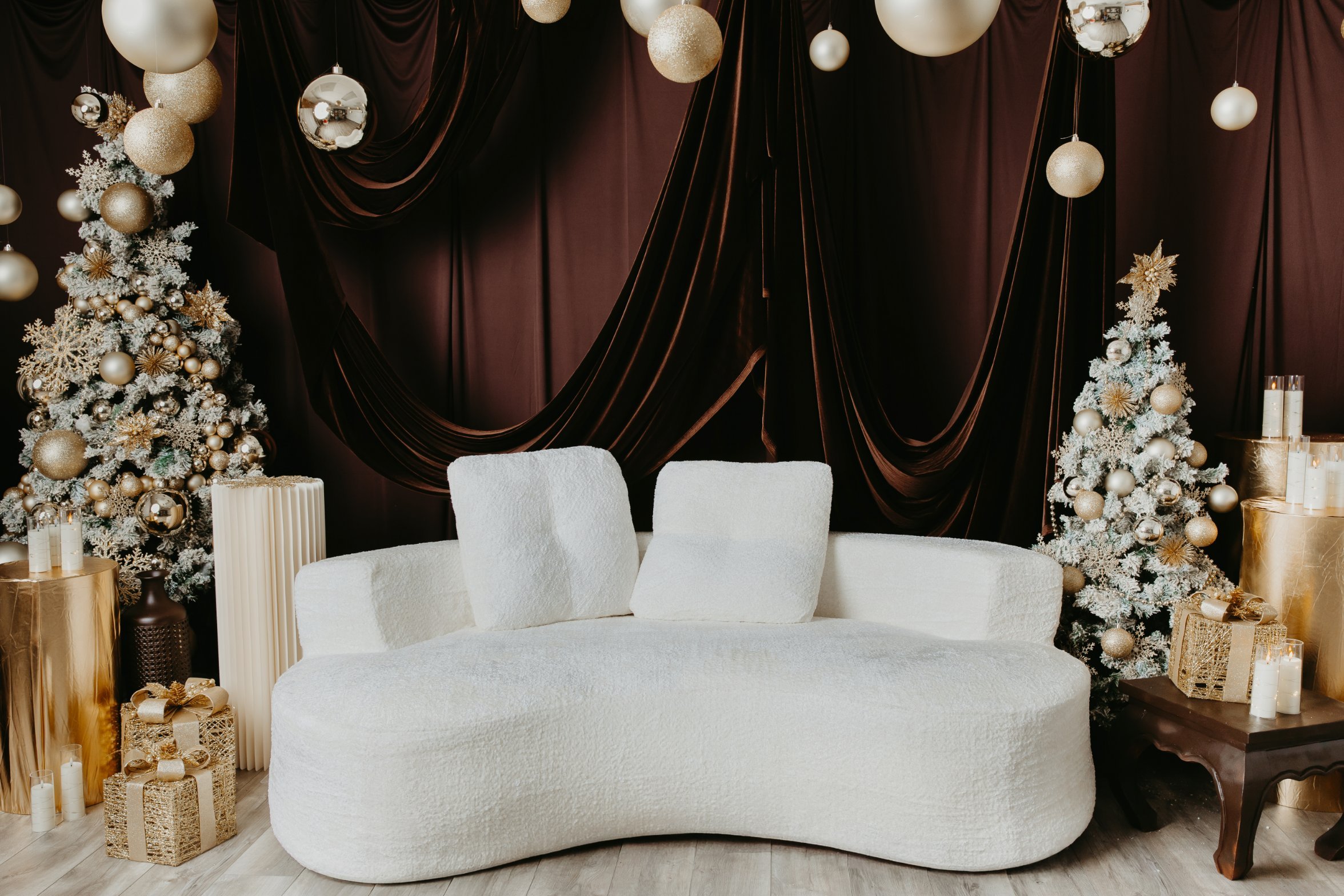 Kathleen Lopes Studio 2026 Christmas set with ivory sofa, velvet backdrop and gold ornaments